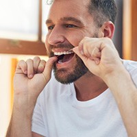 Man flossing his teeth