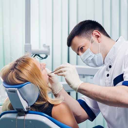 Dentist looking in woman’s mouth