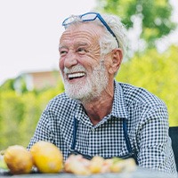 Man smiles outdoors