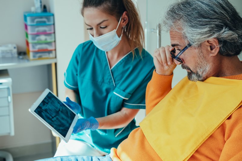 patient learning about dental implant placement 