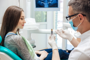 Dentist explaining dental implant salvage to a patient